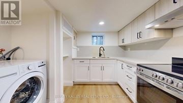 Toronto (Lawrence Park South) multi-family for rent - A modern kitchen with a washing machine and a stove top oven.