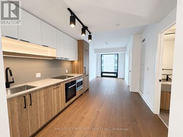 Toronto (Forest Hill South) condo for rent - A modern kitchen with wooden cabinets and a large island.