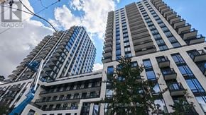 Toronto (Forest Hill South) condo for rent - Two tall buildings with balconies and a blue sky with clouds in the background.