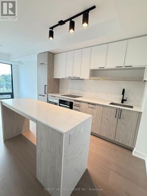 Toronto (Forest Hill South) condo for rent - A modern kitchen with a marble countertop and wooden cabinets.