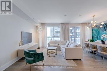 Toronto (Banbury-Don Mills) condo for rent - A living room with a green chair and a white sofa.