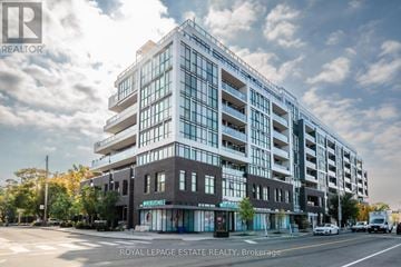 Toronto (East End-Danforth) condo for rent - A modern multi-story building with the words "Royal LePage Estate Realty, Brokerage" on the front.