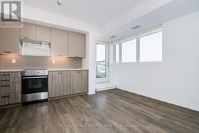 Toronto (East End-Danforth) condo for rent - A kitchen with wooden floors and a stainless steel oven.