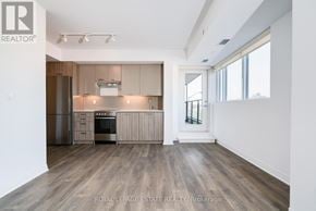 Toronto (East End-Danforth) condo for rent - A spacious kitchen with wooden floors and modern appliances.