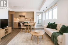 Toronto (East End-Danforth) condo for rent - A modern living room with a dining table and chairs.