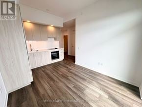Vaughan (Vaughan Corporate Centre) condo for rent - A well-lit kitchen with wooden flooring and white walls.