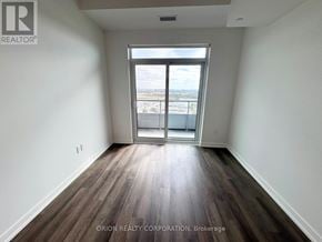 Vaughan (Vaughan Corporate Centre) condo for rent - A room with wooden floors and a large window overlooking a cityscape.