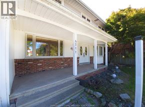 Windsor apartment for rent - A house with a white porch and a brick wall.