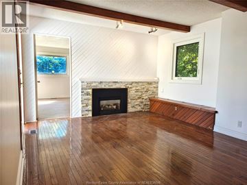 Windsor apartment for rent - A living room with a fireplace and a painting on the wall.