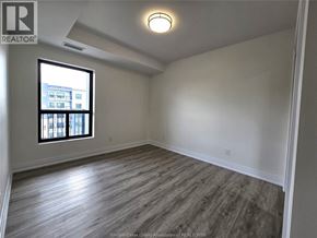 Windsor condo for rent - A room with a window and wooden flooring.