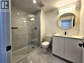 Windsor condo for rent - A bathroom with a toilet, sink, and shower.