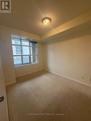 Toronto (Waterfront Communities) condo for rent - A room with a carpeted floor and a window.