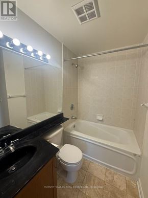 Toronto (Waterfront Communities) condo for rent - A bathroom with a toilet, sink, and bathtub.