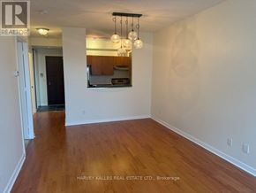 Toronto (Waterfront Communities) condo for rent - A room with wooden floors and a mirror on the wall.