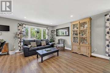 Springwater (Snow Valley) apartment for rent - A living room with a grey couch and a wooden cabinet.