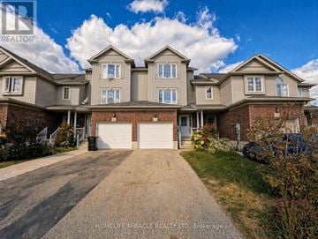 Kitchener townhouse for rent - A large, well-maintained house with a driveway in front.