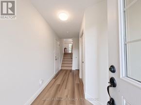 Kitchener townhouse for rent - A long hallway with wooden floors and white walls.