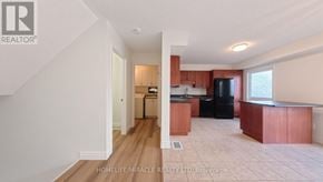 Kitchener townhouse for rent - A kitchen with wooden floors and a refrigerator.