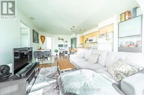 Toronto (Waterfront Communities) condo for rent - A living room with a grey couch and a television.
