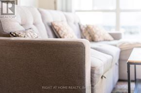 Toronto (Waterfront Communities) condo for rent - A couch with pillows and a small table in front of it.