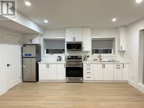 Mississauga (Lakeview) apartment for rent - A modern kitchen with white cabinets and stainless steel appliances.