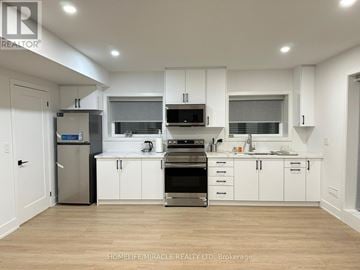 Mississauga (Lakeview) apartment for rent - A modern kitchen with white cabinets and stainless steel appliances.