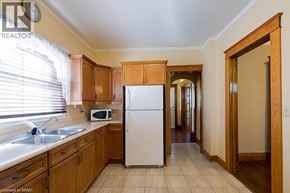 Niagara Falls apartment for rent - A kitchen with wooden cabinets and a white refrigerator.