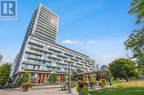 Toronto (Niagara) condo for rent - A tall residential building with a park in front.