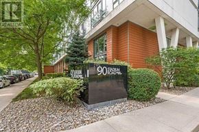 Toronto (Niagara) condo for rent - A building with a sign that reads "90 STADIUM ROAD" is surrounded by greenery.