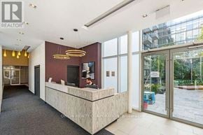 Toronto (Niagara) condo for rent - A reception area with a desk and a television on the wall.