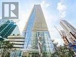 Toronto (Church-Yonge Corridor) condo for rent - A tall skyscraper with a glass facade stands in front of other buildings.