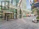 Toronto (Church-Yonge Corridor) condo for rent - A glass building with a tree in front of it.