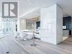Toronto (Church-Yonge Corridor) condo for rent - A modern living room with a white sofa and a glass wall.