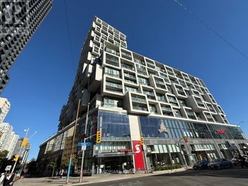 Toronto (Mount Pleasant West) condo for rent - A tall building with a red sign that says "S" on it.