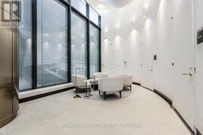 Toronto (Waterfront Communities) condo for rent - A modern office space with a curved wall and glass doors.