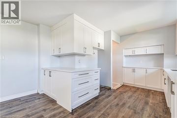 Palmerston apartment for rent - A kitchen with white cabinets and drawers.