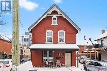 Ottawa duplex for rent - A red brick building with a white awning and a sign that reads "5111" on the front.