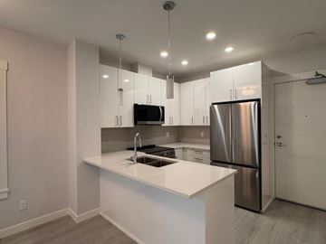 Abbotsford apartment for rent - A modern kitchen with a stainless steel refrigerator and a white countertop.