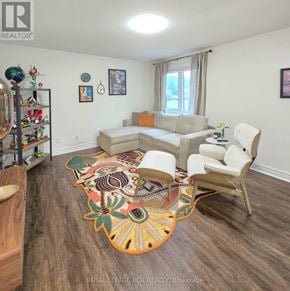 East Gwillimbury triplex for rent - A living room with a couch, chairs, and a rug.