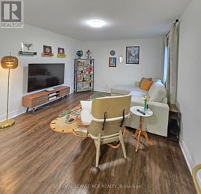 East Gwillimbury triplex for rent - A living room with a television, a couch, a chair, and a rug.