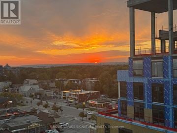 Oakville (Br Bronte) condo for rent - A sunset view from a high rise building with a sign that says "Royal LePage Signature Realty, Brokerage".