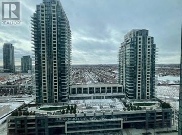 Mississauga (Creditview) condo for rent - Two high-rise buildings are seen from a high vantage point with a parking lot in the foreground.