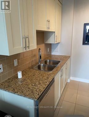 Mississauga (Creditview) condo for rent - A kitchen with granite countertops and white cabinets.
