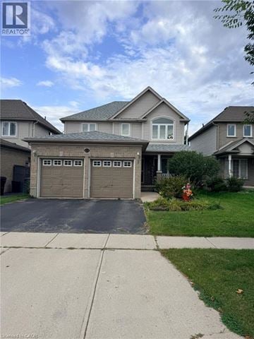 Cambridge apartment for rent - A house with a garage in front of it.
