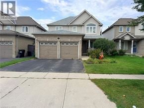 Cambridge apartment for rent - A house with a garage in front of it.