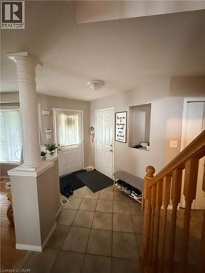 Cambridge apartment for rent - A well lit hallway with a wooden banister.