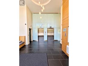 Vancouver apartment for rent - A hallway with a glass door and a bench on the left side.