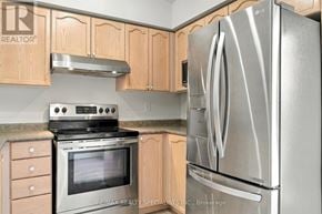 Oakville (Ga Glen Abbey) condo for rent - A kitchen with a stove, oven, and refrigerator.