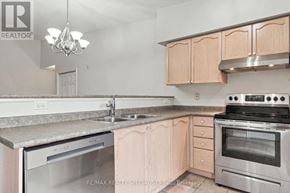 Oakville (Ga Glen Abbey) condo for rent - A kitchen with a stainless steel dishwasher and oven, and wooden cabinets.