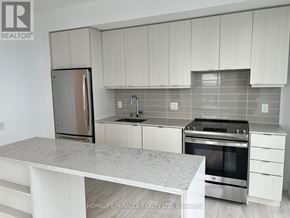 Mississauga (City Centre) condo for rent - A kitchen with white cabinets and a marble countertop.